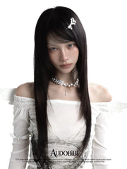 Wing-and-star necklace, worn with other jewelry in a model portrait.