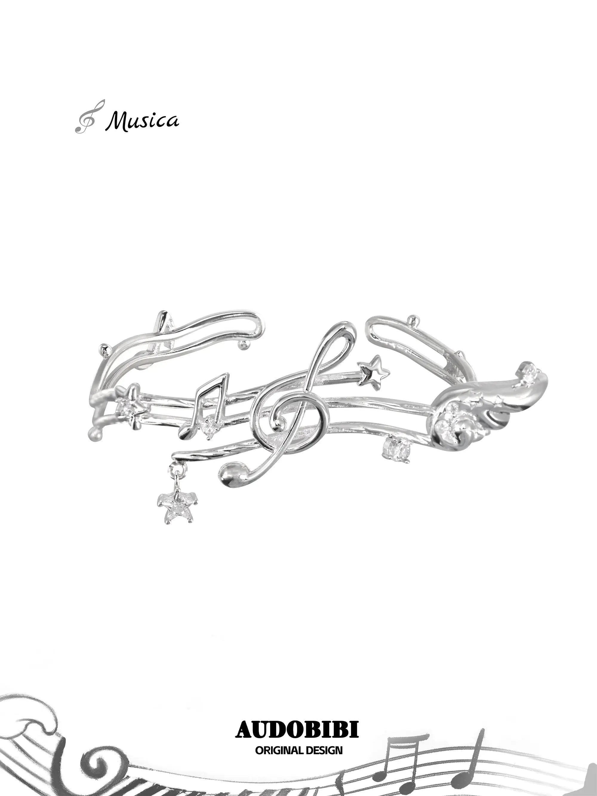 Open bangle shaped like a musical staff, with wing and hanging-star details.